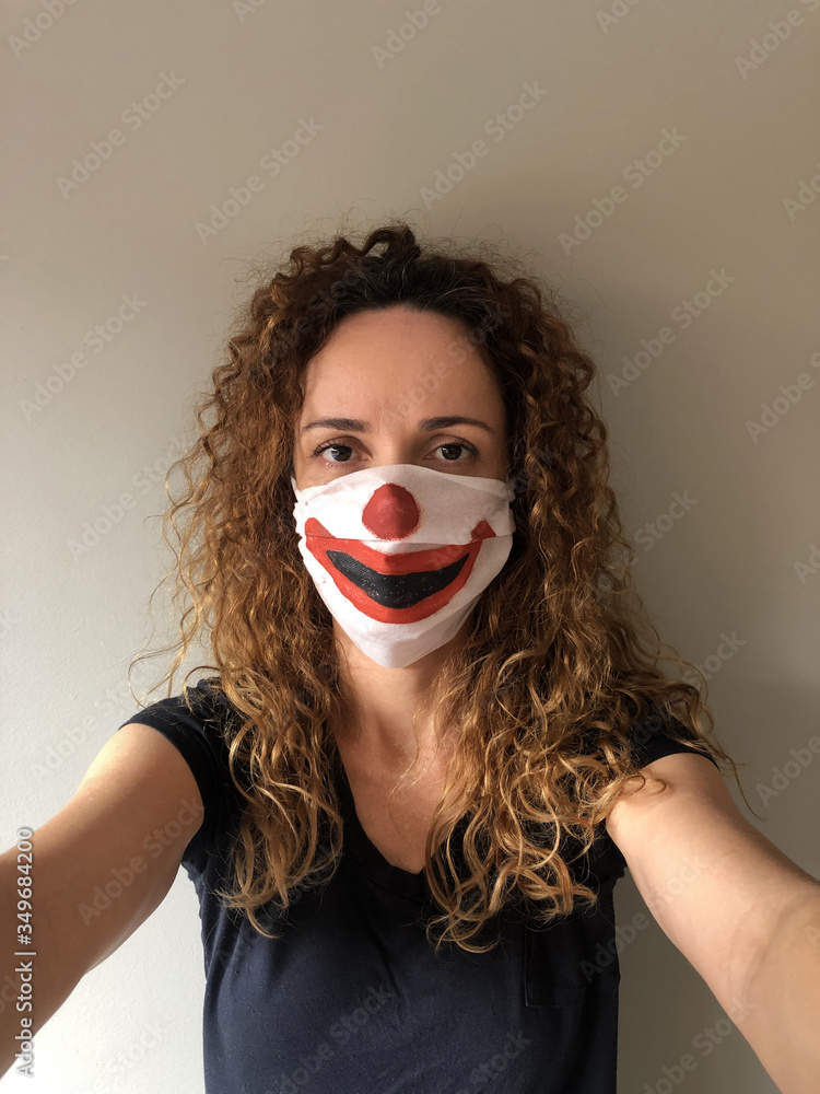 Woman with protective mask painted as a clown in São Paulo, with the feeling of having been deceived.