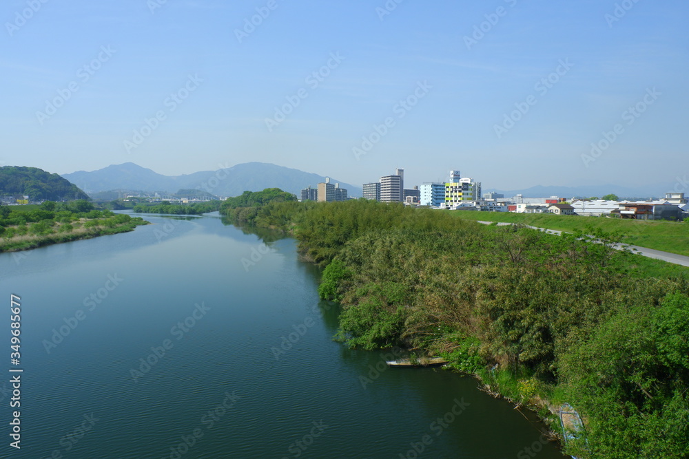 Naklejka premium River landscape in early summer with beautiful greenery