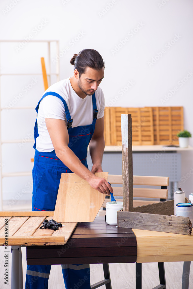 Young male contractor working in workshop Young male contractor working in workshop