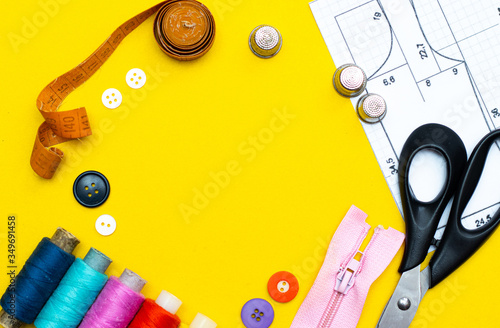 Layout sewing. needlework, craft, sewing and tailoring concept - box with thread spools and buttons on the table. The concept of sewing accessories. Flat lay, Sewing and needlework frame with place fo photo