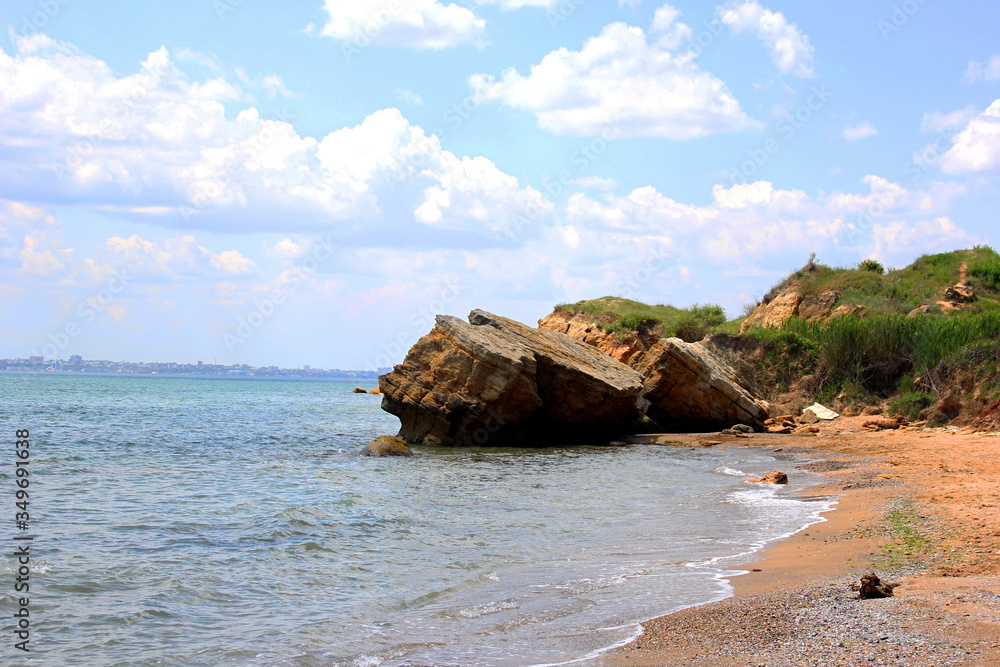 Fototapeta premium Beautiful wild Beach Fontanka near Odessa. Yellow and red sandstone cliffs are located on the seafront. Sunny day