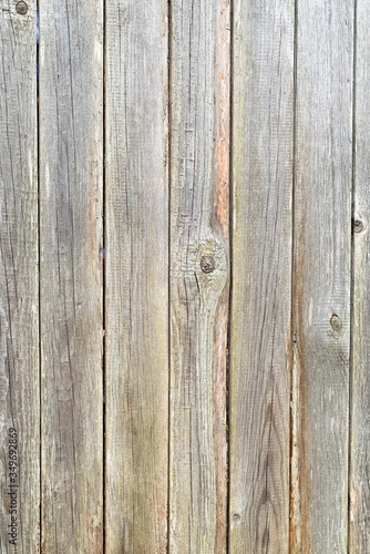 Old plank wooden unpainted gray fence.