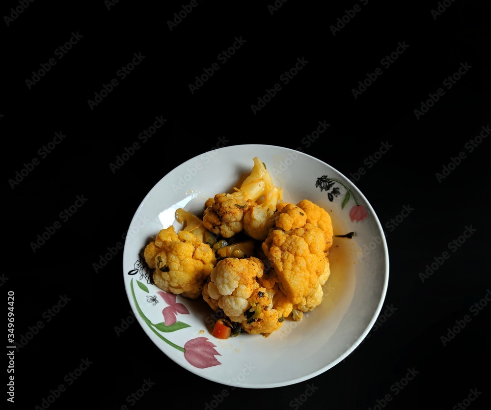 Stewed cauliflower dish on black background. typical food of Guatemala Stewed cauliflower dish on black background. typical food of Guatemala