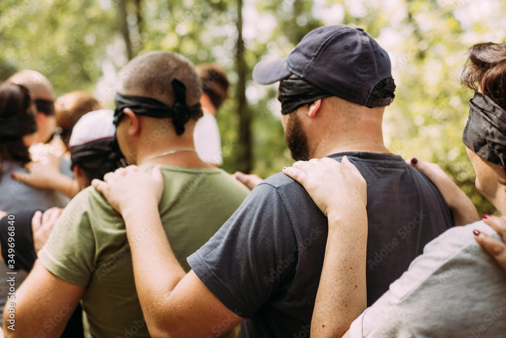 Blindfolded woman holding hands out in front of herself