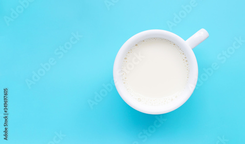 Cup of milk on blue background.