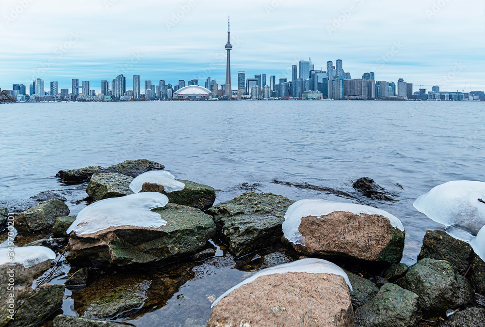 Frozen rocks with Toronto skyline as background