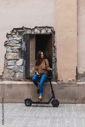 Woman with electric scooter on the street