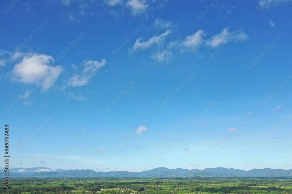 Aerial View of drone flying White clouds floating on the green mountains