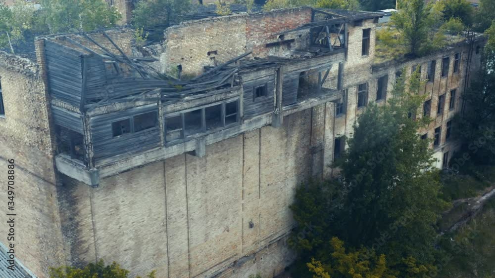 Aerial view of the abandoned old ruins of a building with broken windows. Old industrial building for demolition. Aerial view of the abandoned old ruins of a building with broken windows. Old industrial building for demolition.