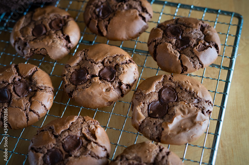 soft dark chocolate brownie cookies on a metal rack on a wooden background.