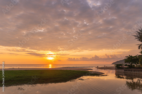 .sunset behind golden dragon statue on Karon beach Phuket Thailand © Narong Niemhom