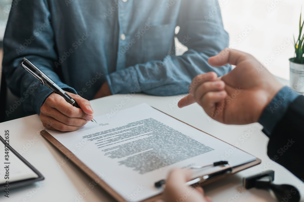 Businessman and lawyer discuss the contract document. Treaty of the law. Sign a contract business. Businessman and lawyer discuss the contract document. Treaty of the law. Sign a contract business.
