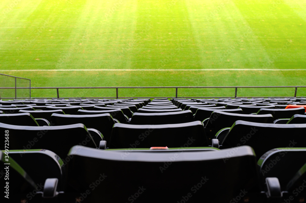 An empty rows of plastic seats in football stadium. Stadium ...