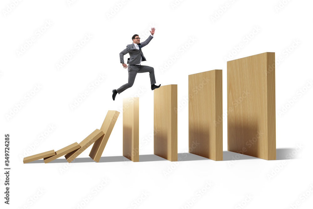 Fototapeta premium Businessman in domino effect concept