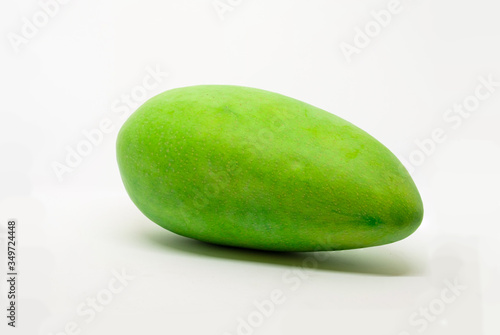 Mango fruit with shadows placed horizontally on a isolated white background.