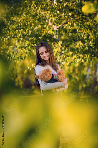 Wallpaper Mural Attractive young woman hugging plush toys, soft light. Torontodigital.ca