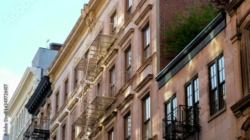 Classic building with fire escapes and roof top plants