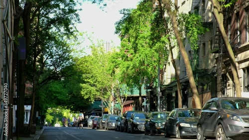 Spring day on a beautiful city street with people riding along it.