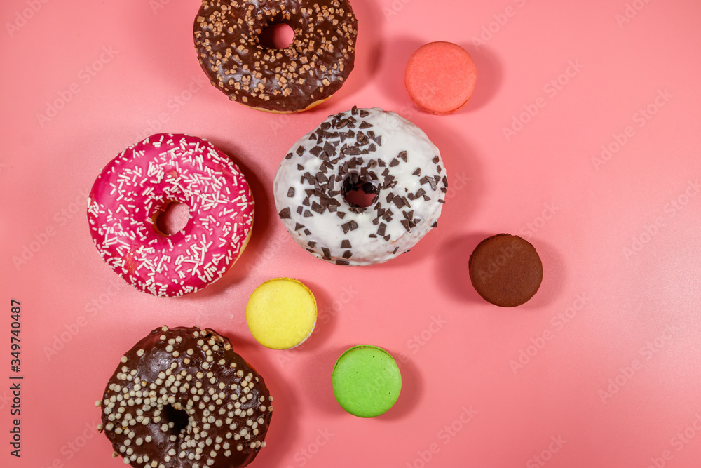 Tasty donuts and macaroons on pink background. Top view Tasty donuts and macaroons on pink background. Top view
