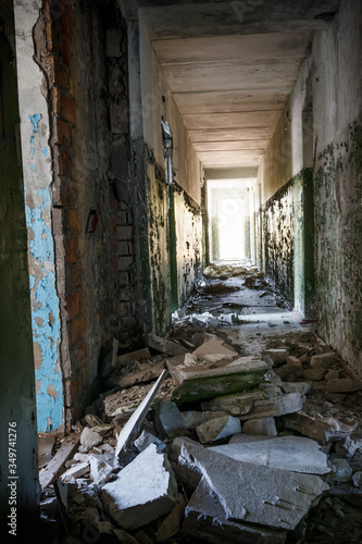 Long corridor of ruined abandoned house © olyasolodenko