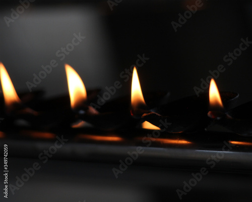 soil or clay lamp radiating light in dark. concept of removing darkness with a flame. These types of lamps are common in India and Nepal, especially in Diwali. the lamp has oil and a cotton wick.