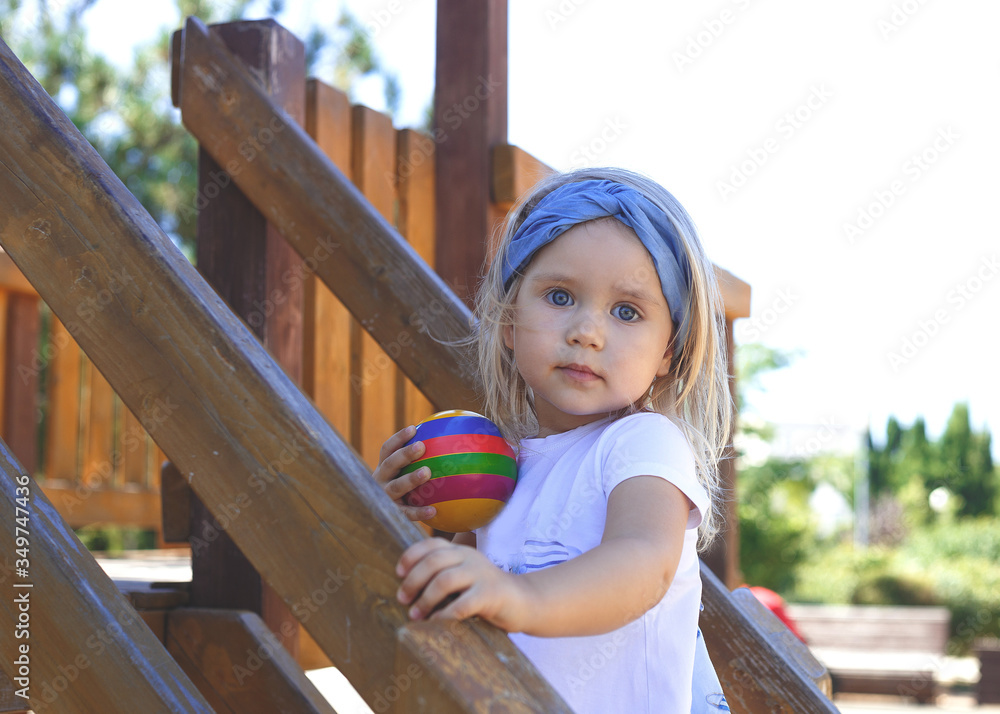 little blue-eyed girl plays in the playground little blue-eyed girl plays in the playground