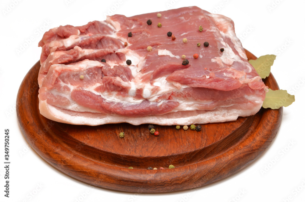 pork on a wooden board piece of raw meat isolated on a white background