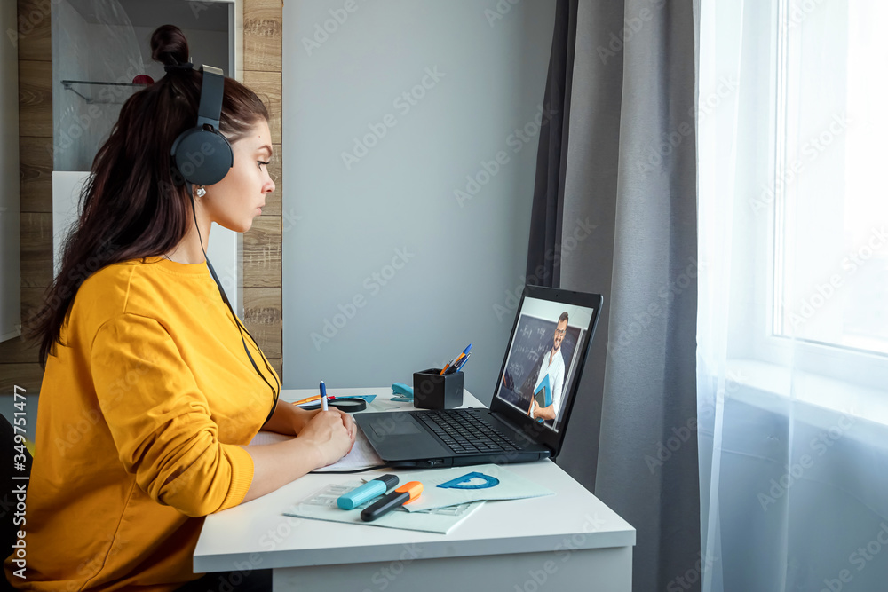 Beautiful girl using laptop studying at home, online education concept, studying science behind a laptop. Watching a webinar, looking for friends on social networks. Modern technologies. Beautiful girl using laptop studying at home, online education concept, studying science behind a laptop. Watching a webinar, looking for friends on social networks. Modern technologies.