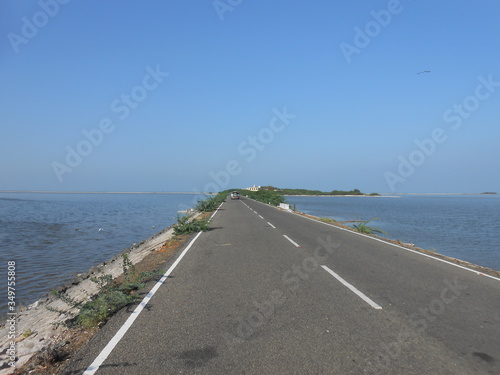 Vast stretch of road in Dhanushkodi, a single stretch of road dissecting the ocean waters. Southern tip of India.At the end of this road, India ends and Sri lanka starts. Ocean Borders, beautiful sun.