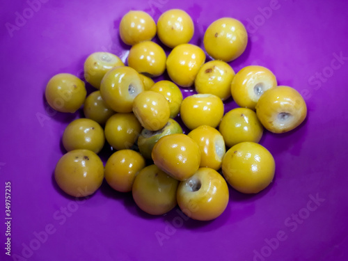 Dish served with Nances inside, tropical seasonal fruit, Byrsonima crassifolia in Guatemala.

 photo