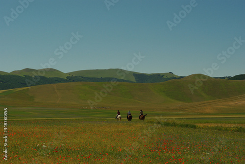 Horseback riding on the Castelluccio da Norcia plateau. Umbria, Italy