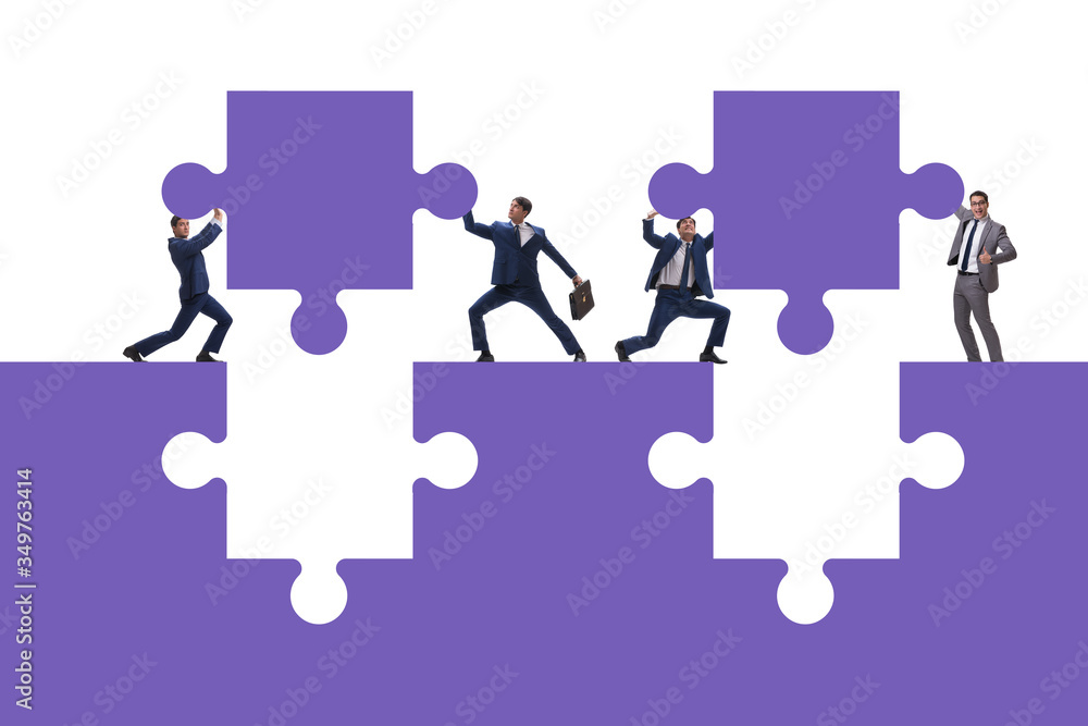 Businessman in teamwork concept with jigsaw puzzle Businessman in teamwork concept with jigsaw puzzle