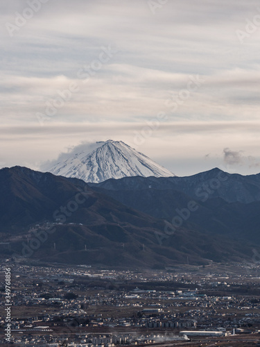 The tip of Mt. Fuji rising above the surrounding mountains