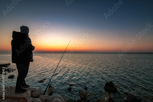 Man fishing silhoutte in uqair port area -Saudi Arabia
