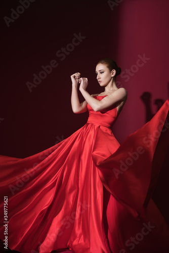 Young beauty woman in fluttering red dress