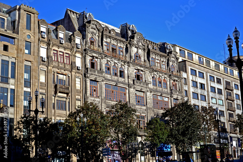 Porto, Portugal - August 18, 2015: Beautiful facade of an abandoned building in the historic center of Porto. Many of the windows are broken and the balconies rust.