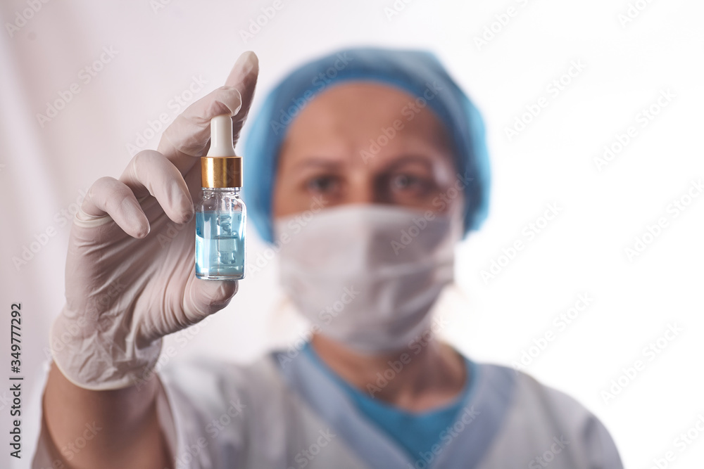 Doctor holds in his hands the drip with the drug. Doctor holds in his hands the drip with the drug.