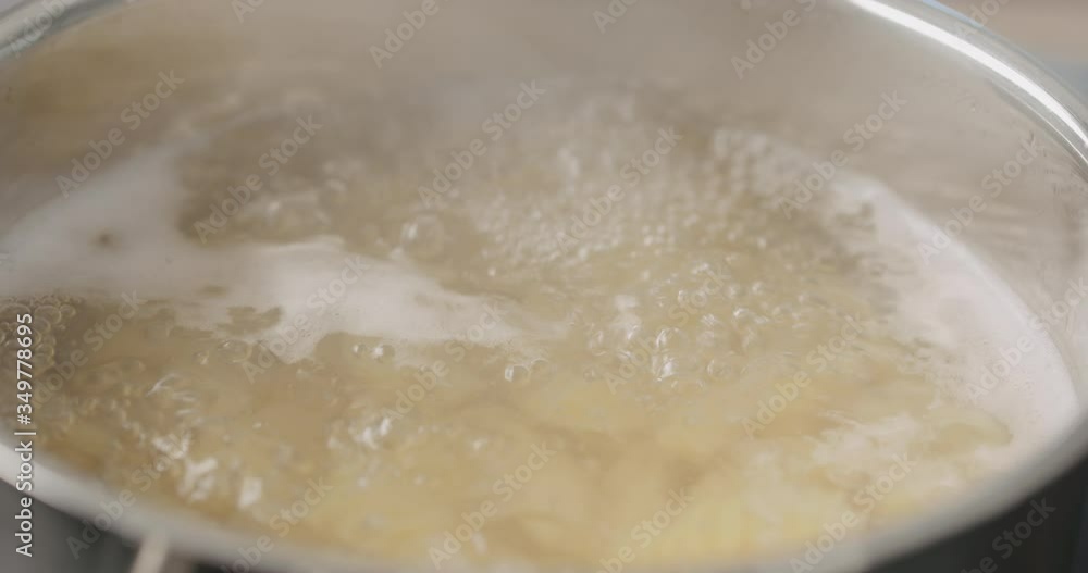 Slow motion of boiling fusilli pasta in saucepan closeup Slow motion of boiling fusilli pasta in saucepan closeup