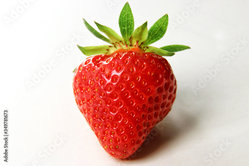 Red summer strawberries, fresh fruit on a white background