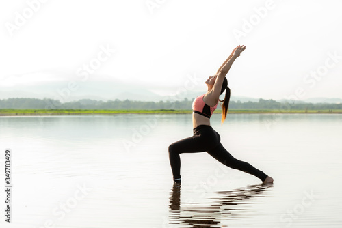 Lifestyle woman yoga exercise and pose for healthy life. Young girl or people pose balance body vital zen and meditation for workout sunrise morning nature background. Healthy Concept
