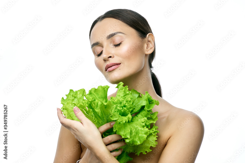 portrait of a girl with clean skin without makeup with a leaf of green salad portrait of a girl with clean skin without makeup with a leaf of green salad