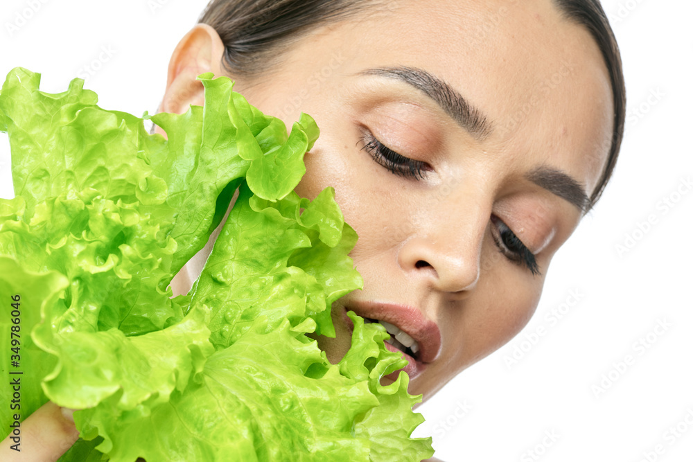 portrait of a girl with clean skin without makeup with a leaf of green salad portrait of a girl with clean skin without makeup with a leaf of green salad