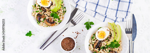 Breakfast oatmeal porridge with green herbs of mushrooms, boiled egg, avocado and flax seeds. Healthy balanced food. Top view, overhead,  banner