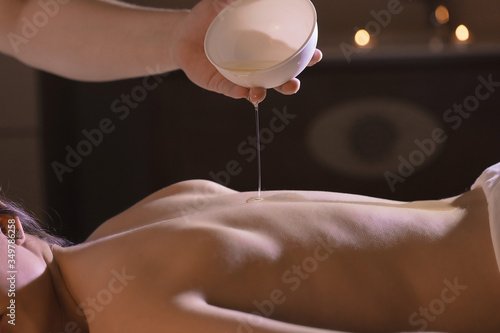 Wellness back massage with coconut oil for a beautiful girl and body treatments