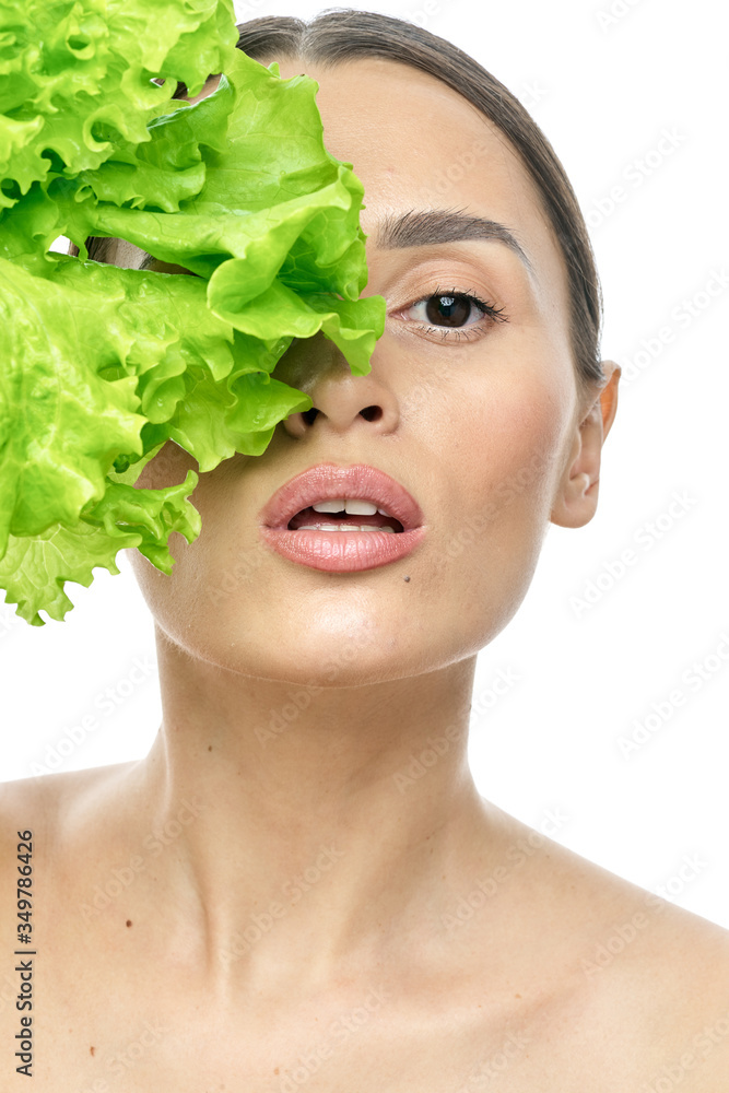 portrait of a girl with clean skin without makeup with a leaf of green salad portrait of a girl with clean skin without makeup with a leaf of green salad