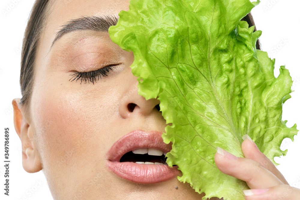 portrait of a girl with clean skin without makeup with a leaf of green salad portrait of a girl with clean skin without makeup with a leaf of green salad