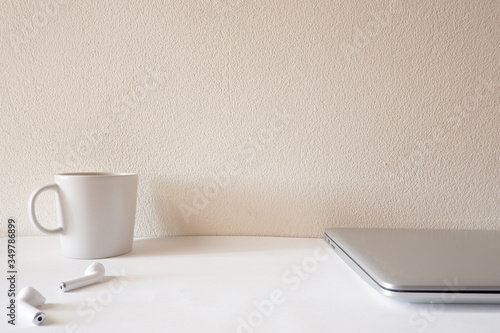 Front view  of white office desk table with the office equipments, computer keyboard and other office supplies on the modern space, flat lay.