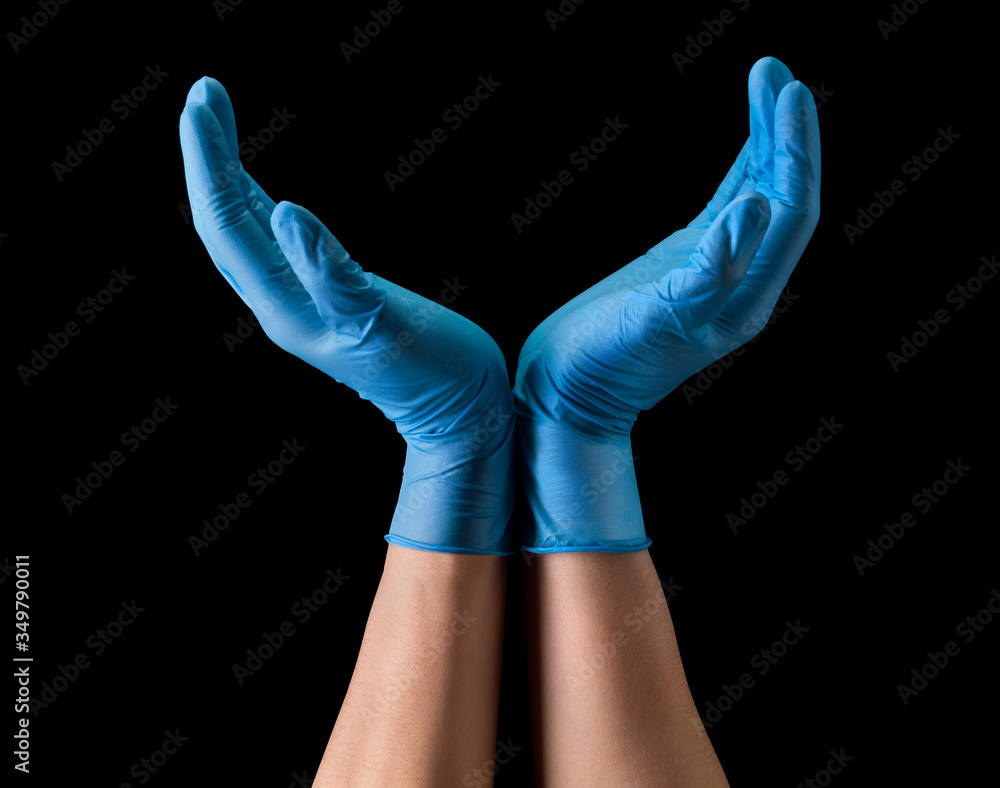 Doctor's hand in sterile medical gloves hold earth shape isolated on black Doctor's hand in sterile medical gloves hold earth shape isolated on black