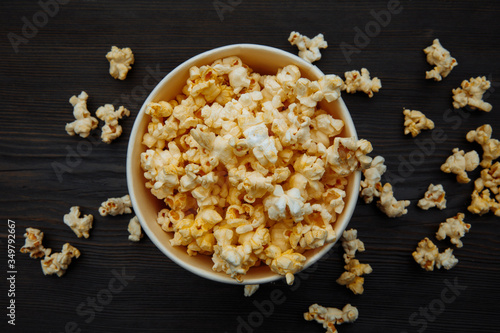 Bowl with popcorn on wooden background. Top view. Entetainement concept.