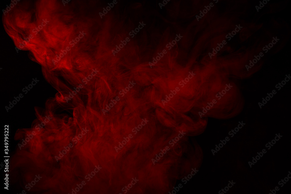 Colorful smoke close-up on a black background. Red cloud of smoke. Colorful smoke close-up on a black background. Red cloud of smoke.